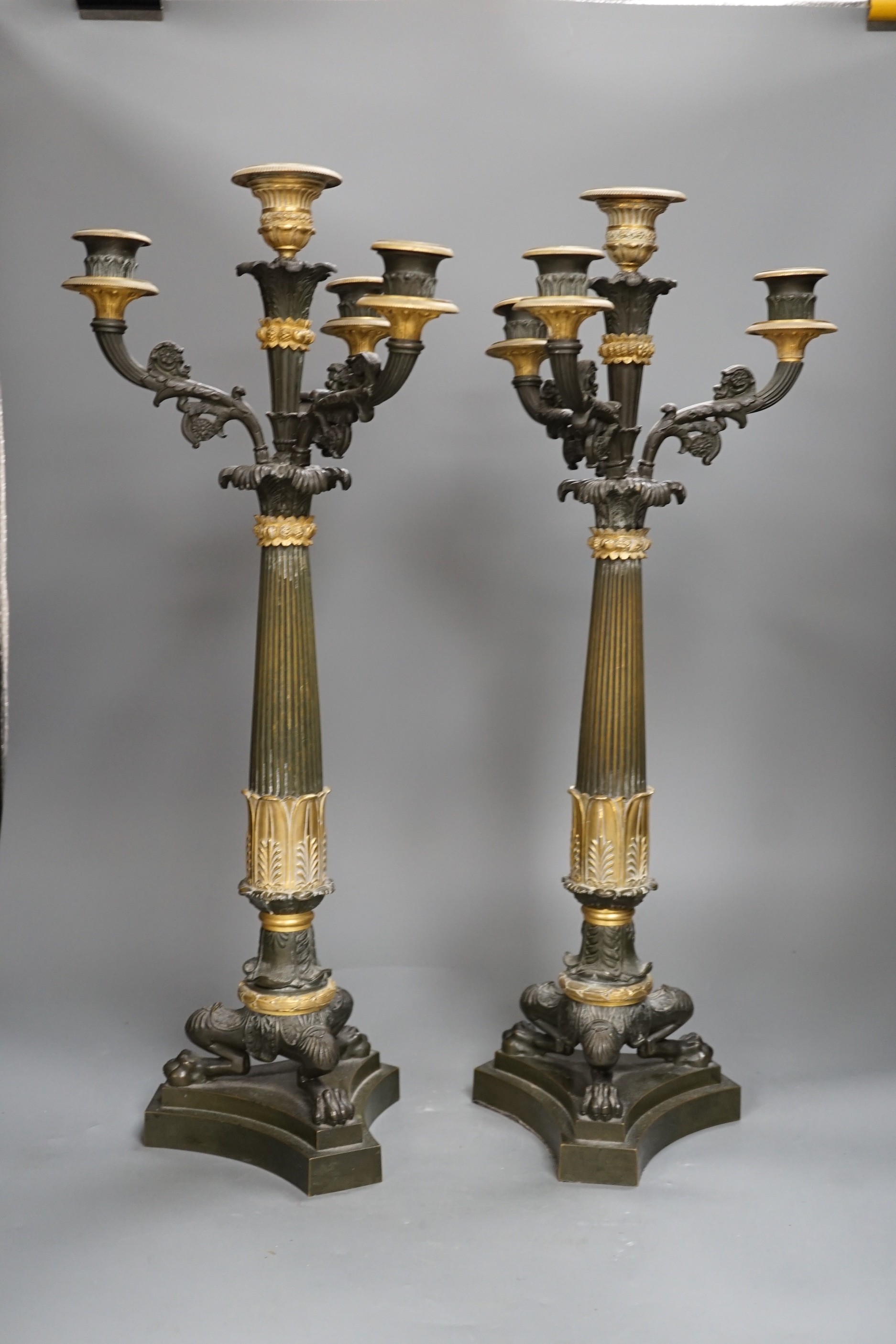 A pair of 19th century French Empire style bronze and gilt metal three branch, four light candelabra, 54cms high